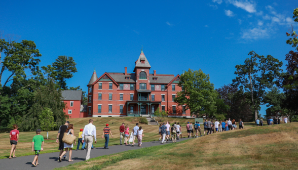 Students walk up the road by East Hall