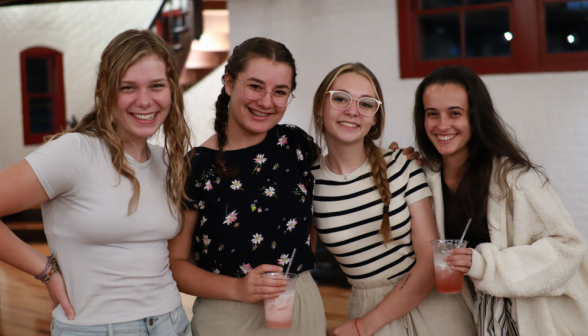 Four pose with drinks