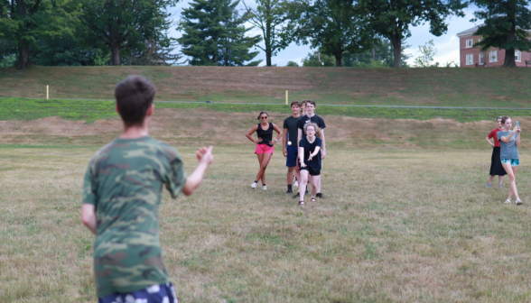 A student gently tosses an egg to her teammate