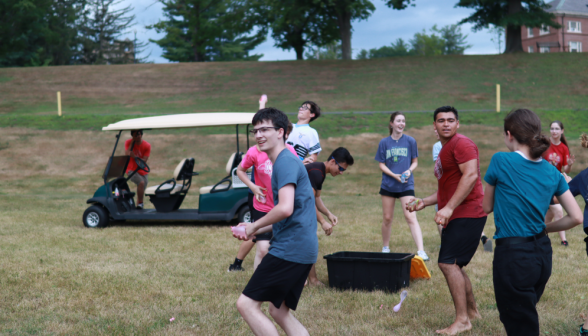 Students and prefects mid-throw