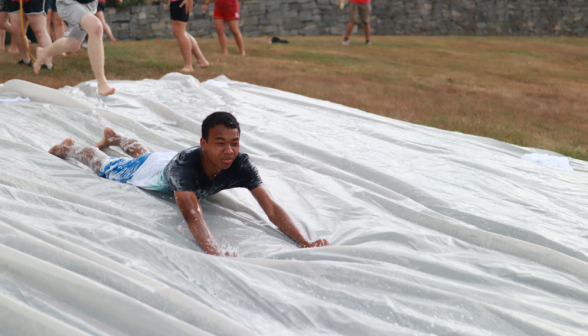 A student speeds down the slide