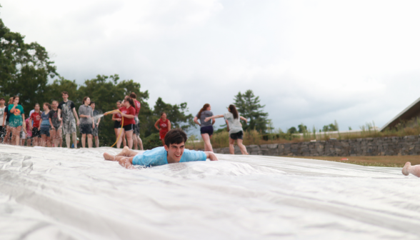 A student speeds down the slide