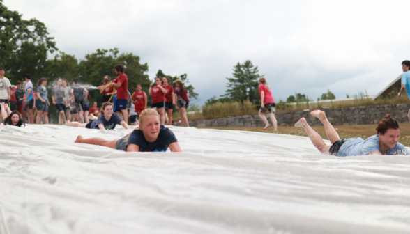 Another student goes down the slide