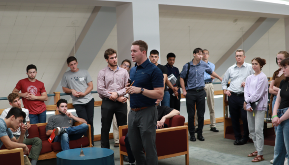 John Jost addresses the students in the library