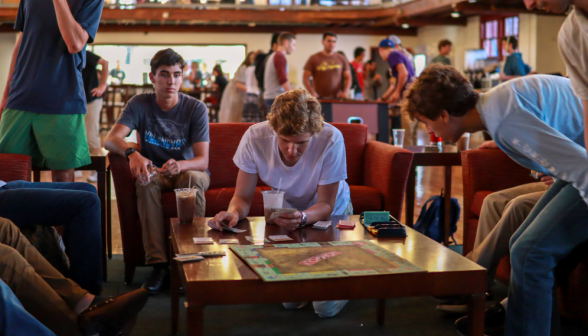 Students play Monopoly over drinks