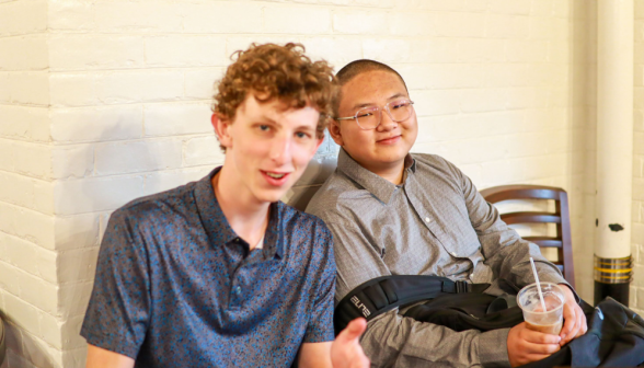 Two students smile for the camera