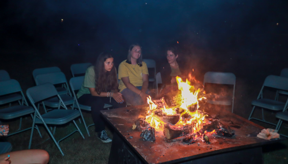 Three chat by the fire