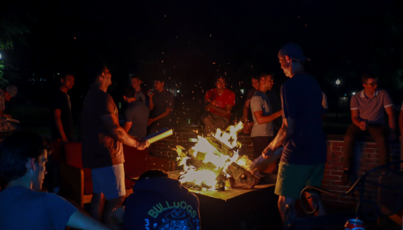 At the men's dorm: students around the campfire