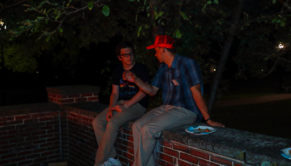 Two chat on the Merrill-Keep courtyard wall