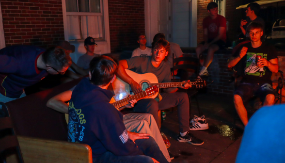 Students playing guitar at the men's dorm