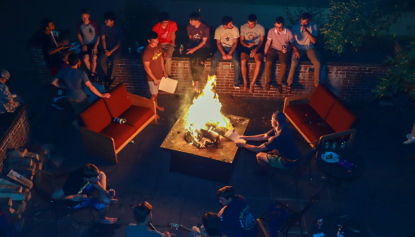 Long shot of the Merrill courtyard with bonfire and students
