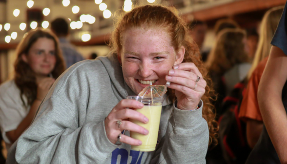 A student poses with her drink