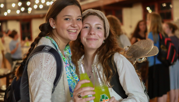 Two students pose with their drinks