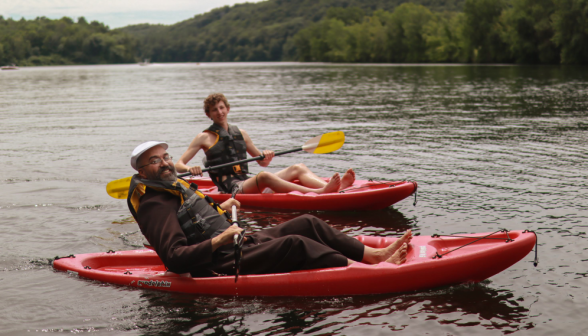 Fr. Viego and a student in their kayaks, out on the river