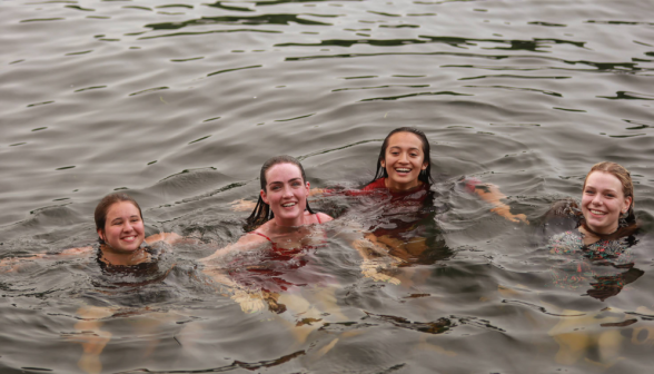 Four people bobbing in the water