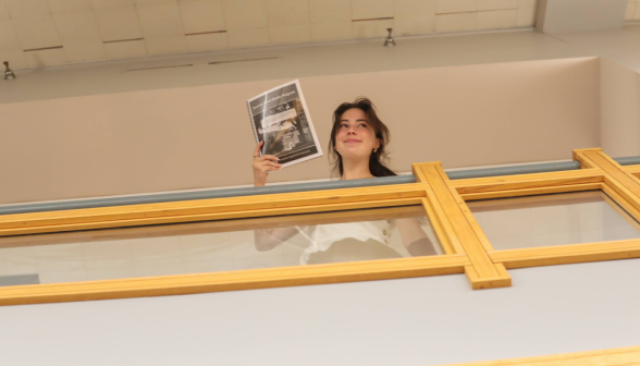 A prefect leans over the railing