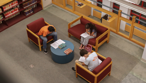 Three study in armchairs and a couch around a small, circular table