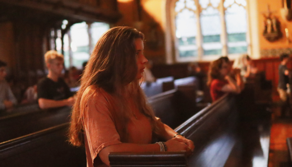 A student prays the Rosary in the Chapel