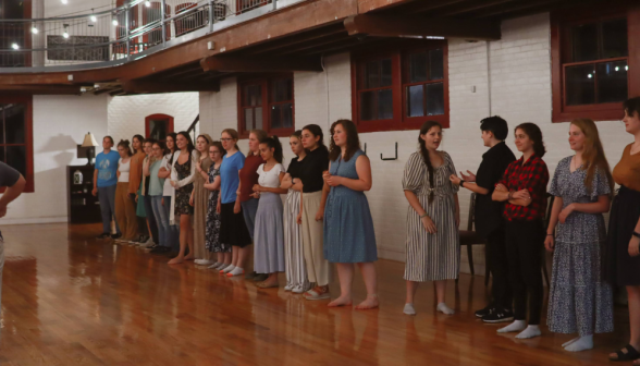 Students line up on one side of the room