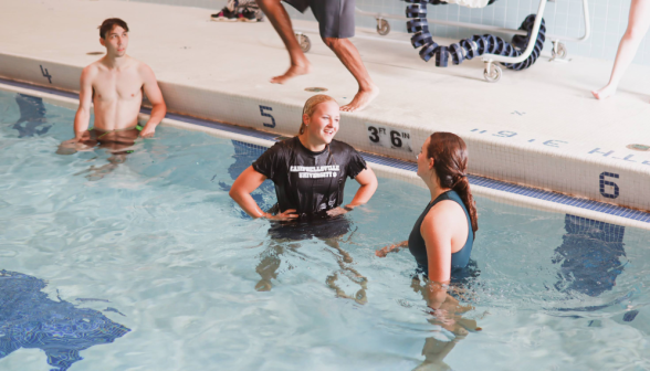 Students laugh and chat in the pool