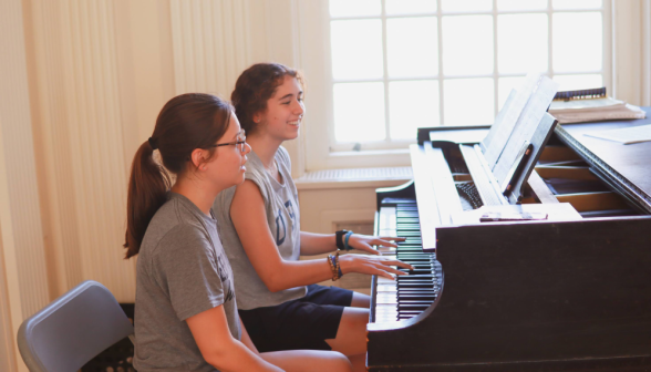 Two play the piano in the Commons