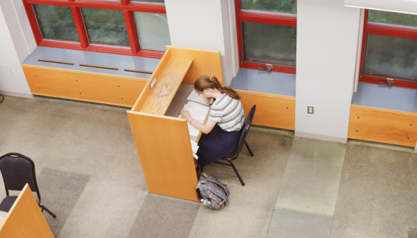 A student studies at an individual desk