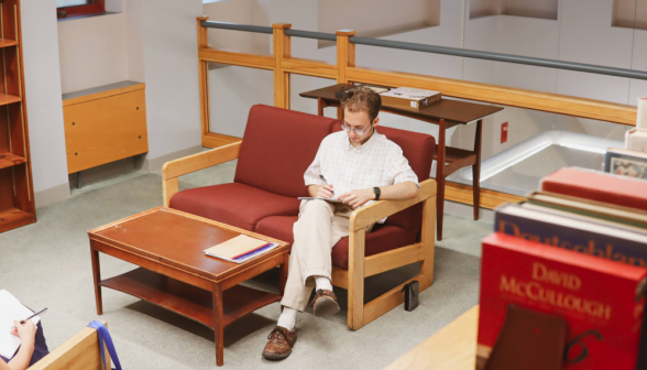 A student studies on a couch