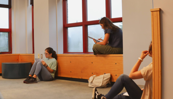 Three studying around a room