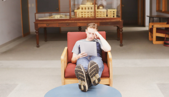 A student studies in an armchair