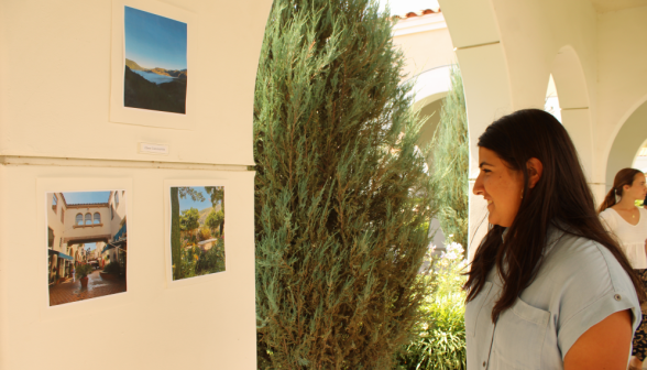 A student examines three photographs