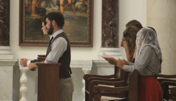 Students pray in the pews