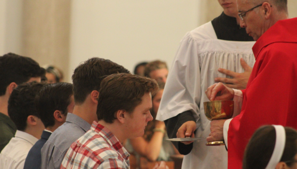 Students receive Communion at the rail