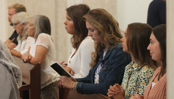 Students pray in the pews