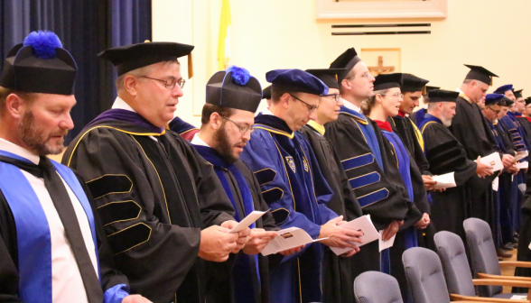 Tutors in a row sing a hymn