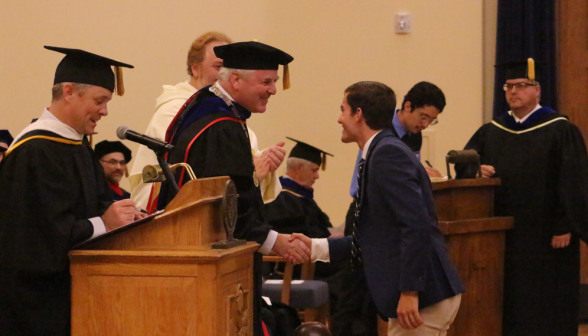 President O'Reilly shakes the hand of an incoming freshman