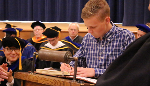 A student signs the register