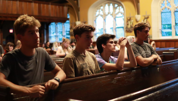 A row of students praying