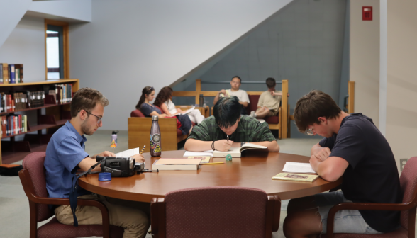 Three studying at a circular table