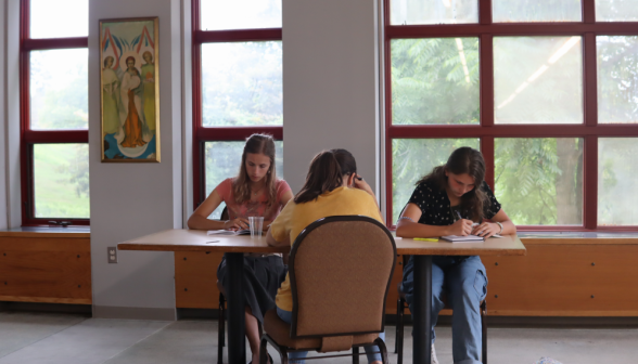 Three study at a rectangular table