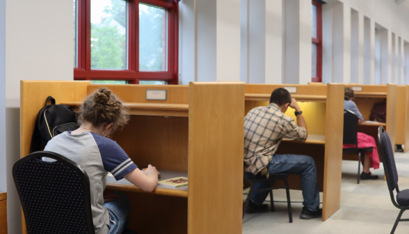 A row of students at individual desks