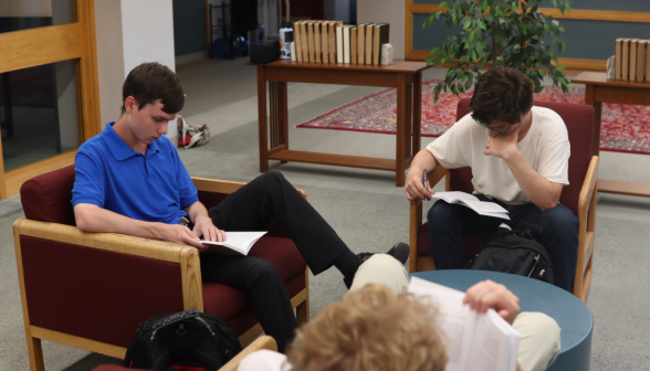 Three in armchairs around a circular table