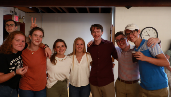 Eight students pose for a picture