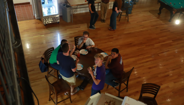 Overhead view of students eating pizza