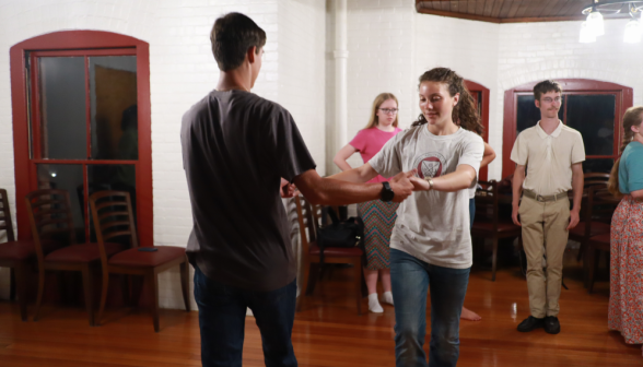 Two practice dancing on the upper floor