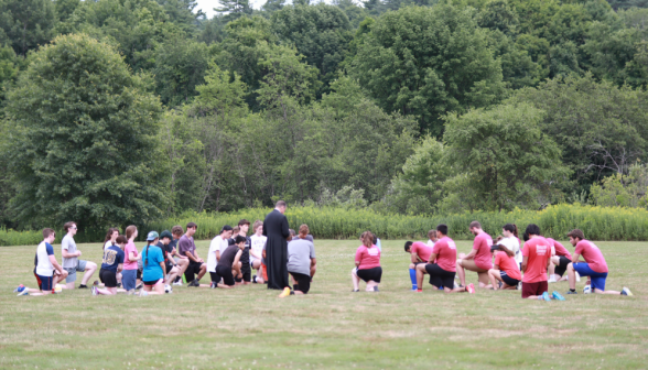 Fr. Markey leads the students in prayer pre-game