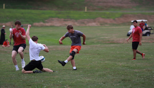 A student blocks the ball with his body