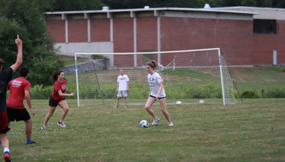 Students playing soccer by one of the nets