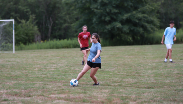 A student kicks the ball