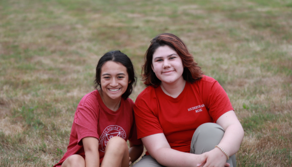 Two seated smile for the camera