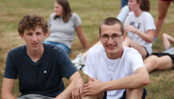 Two seated smile for the camera